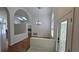 Open-concept living space with vaulted ceilings and access to outdoor areas at 15209 Arbor Hollow Dr, Odessa, FL 33556