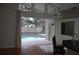 Serene pool area view with a cozy outdoor living space and natural light at 15209 Arbor Hollow Dr, Odessa, FL 33556