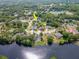 Aerial view of a home and lush community, highlighting waterfront property on a lake at 17205 Tiffany Shore Dr, Lutz, FL 33549