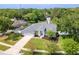 Stunning aerial view of home showcasing lush landscaping, well-manicured lawn, and serene lake views at 17205 Tiffany Shore Dr, Lutz, FL 33549