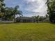 Wide shot of the backyard showcasing the screened pool, lawn, and perimeter fencing at 17205 Tiffany Shore Dr, Lutz, FL 33549