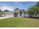 Charming one-story home featuring a well-kept lawn and a two-car garage at 17205 Tiffany Shore Dr, Lutz, FL 33549