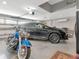 Spacious three car garage featuring a motorcycle and a black SUV at 17205 Tiffany Shore Dr, Lutz, FL 33549