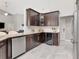 Beautiful kitchen with granite counters, dark cabinetry, stainless steel appliances, and a wine cooler at 17205 Tiffany Shore Dr, Lutz, FL 33549