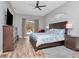 Spacious main bedroom offers wood floors, ceiling fan, natural light and private access to the pool area at 17205 Tiffany Shore Dr, Lutz, FL 33549