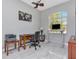 Bright office with large window, light gray walls, tile flooring, and a ceiling fan at 17205 Tiffany Shore Dr, Lutz, FL 33549