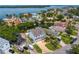 Aerial view showcases a waterfront home with a dock and lush landscaping in a desirable neighborhood at 1739 1/2 Bayou Grande Ne Blvd, St Petersburg, FL 33703