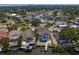 Aerial view of waterfront home featuring a private pool, boat dock, and tropical landscaping at 1739 1/2 Bayou Grande Ne Blvd, St Petersburg, FL 33703