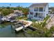 A waterfront home with a boat lift, tiki bar, pool and lush landscaping for luxurious outdoor living at 1739 1/2 Bayou Grande Ne Blvd, St Petersburg, FL 33703