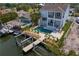 Waterfront property featuring a boat lift, lush landscaping, and private pool, perfect for relaxing by the water at 1739 1/2 Bayou Grande Ne Blvd, St Petersburg, FL 33703