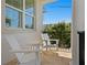 Cozy balcony with white rocking chairs overlooking the greenery at 1739 1/2 Bayou Grande Ne Blvd, St Petersburg, FL 33703