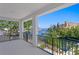 Balcony with black metal railings offers picturesque views of the water, boats, and surrounding buildings at 1739 1/2 Bayou Grande Ne Blvd, St Petersburg, FL 33703