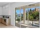 Expansive balcony with waterfront views, light wood floors, and access to kitchen at 1739 1/2 Bayou Grande Ne Blvd, St Petersburg, FL 33703