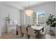 Inviting dining room with modern chandelier, table with seating for six, and neutral decor at 1739 1/2 Bayou Grande Ne Blvd, St Petersburg, FL 33703