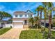 Inviting two-story home featuring a brick driveway and lush landscaping at 1739 1/2 Bayou Grande Ne Blvd, St Petersburg, FL 33703