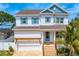 Charming two-story home with classic design elements, blue shutters, and an inviting entrance at 1739 1/2 Bayou Grande Ne Blvd, St Petersburg, FL 33703