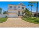 Charming two-story home featuring a brick driveway, manicured lawn and a two-car garage at 1739 1/2 Bayou Grande Ne Blvd, St Petersburg, FL 33703