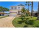 Beautiful two-story home with a well-manicured lawn and palm trees at 1739 1/2 Bayou Grande Ne Blvd, St Petersburg, FL 33703
