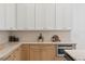 Bright kitchen features light oak cabinets, stone countertops, and neutral backsplash at 1739 1/2 Bayou Grande Ne Blvd, St Petersburg, FL 33703