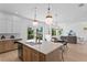 Open concept kitchen featuring an island, stainless appliances, and seamless flow to dining and living areas at 1739 1/2 Bayou Grande Ne Blvd, St Petersburg, FL 33703