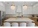 Close up of the kitchen island with white countertops, farmhouse sink and designer pendant lighting at 1739 1/2 Bayou Grande Ne Blvd, St Petersburg, FL 33703