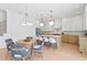 Bright eat-in kitchen featuring a center island, modern pendant lighting, and stainless steel appliances at 1739 1/2 Bayou Grande Ne Blvd, St Petersburg, FL 33703