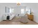 Bright living room with ample seating features wood floors, modern lighting, and neutral decor at 1739 1/2 Bayou Grande Ne Blvd, St Petersburg, FL 33703