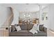Open concept living room with stairs, hardwood floors and gourmet kitchen in the background at 1739 1/2 Bayou Grande Ne Blvd, St Petersburg, FL 33703