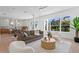 Bright open concept living room with modern furnishings and views into the gourmet kitchen at 1739 1/2 Bayou Grande Ne Blvd, St Petersburg, FL 33703