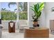 Bright living room features a comfortable chair with an oversized window view at 1739 1/2 Bayou Grande Ne Blvd, St Petersburg, FL 33703