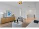 Bright loft with ample seating features wood floors, modern lighting, and neutral decor at 1739 1/2 Bayou Grande Ne Blvd, St Petersburg, FL 33703