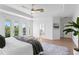 Main bedroom features balcony access, smooth wood floors, and modern decor for a relaxing retreat at 1739 1/2 Bayou Grande Ne Blvd, St Petersburg, FL 33703