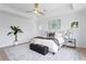 Bright main bedroom boasts a ceiling fan, soft carpet, and calming decor, centered on a comfortable bed at 1739 1/2 Bayou Grande Ne Blvd, St Petersburg, FL 33703