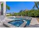 Resort style pool featuring a spa and in-pool lounge chairs, surrounded by lush landscaping at 1739 1/2 Bayou Grande Ne Blvd, St Petersburg, FL 33703