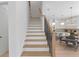 Staircase and open kitchen floor plan features white and light wood finishes and stainless steel appliances at 1739 1/2 Bayou Grande Ne Blvd, St Petersburg, FL 33703