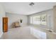 Bright living room featuring terrazzo flooring, a large window and neutral paint at 1809 Stancel Dr, Clearwater, FL 33764