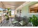 Covered patio with an outdoor dining set surrounded by lush greenery at 1809 Stancel Dr, Clearwater, FL 33764