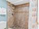 Clean bathroom featuring a tiled shower with safety rail and grab bar at 18400 Gulf Blvd # 1109, Indian Shores, FL 33785