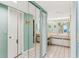 Bright bathroom featuring a vanity with double sinks and tile flooring at 18400 Gulf Blvd # 1109, Indian Shores, FL 33785