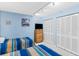 Bedroom features two twin beds, a dresser with a TV, and a closet at 18400 Gulf Blvd # 1109, Indian Shores, FL 33785