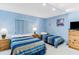 Bright bedroom with two twin beds, window blinds, and neutral walls at 18400 Gulf Blvd # 1109, Indian Shores, FL 33785