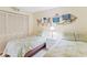 Cozy bedroom featuring two twin beds, closet with louvered doors, and decorative nautical elements at 18400 Gulf Blvd # 1109, Indian Shores, FL 33785