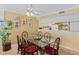 Open dining area with a glass table, seating for six, and decorative wall art with a passthrough to the kitchen at 18400 Gulf Blvd # 1109, Indian Shores, FL 33785