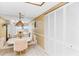 Bright dining area with tiled floors, a mirrored wall, and an adjacent kitchen with great natural light and lots of storage space at 18400 Gulf Blvd # 1109, Indian Shores, FL 33785