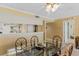 View of the dining area featuring a glass table with seating and a pass-through to the adjacent living and kitchen areas at 18400 Gulf Blvd # 1109, Indian Shores, FL 33785