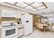 An eat-in kitchen featuring white appliances and tiled floors and lots of natural light, open to the dining area at 18400 Gulf Blvd # 1109, Indian Shores, FL 33785