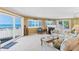 Bright living room with fireplace and beach views from the adjacent balcony and windows at 18400 Gulf Blvd # 1109, Indian Shores, FL 33785