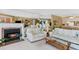 Comfortable living room featuring a fireplace, sofas, and views of the balcony at 18400 Gulf Blvd # 1109, Indian Shores, FL 33785