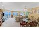Bright living room with glass doors to the balcony with ocean views, with an open floor plan connected to the dining area at 18400 Gulf Blvd # 1109, Indian Shores, FL 33785