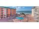 Community pool surrounded by lounge chairs and tables, located steps from the beach at 18400 Gulf Blvd # 1109, Indian Shores, FL 33785